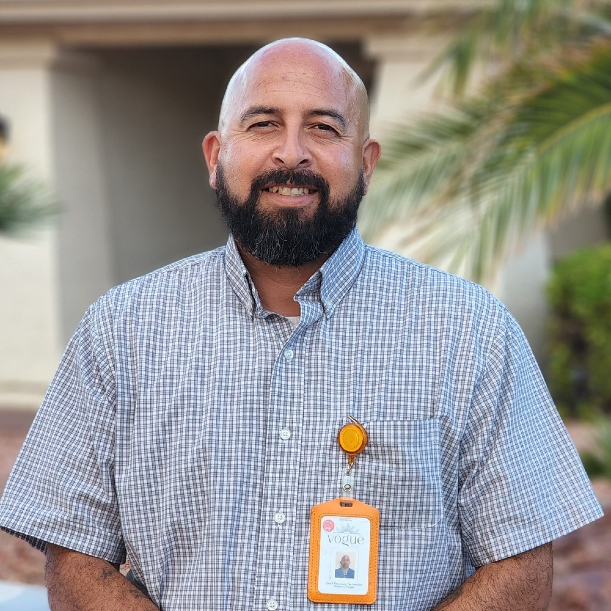 An image of a person formerly sentenced to LWOP wearing a company badge.