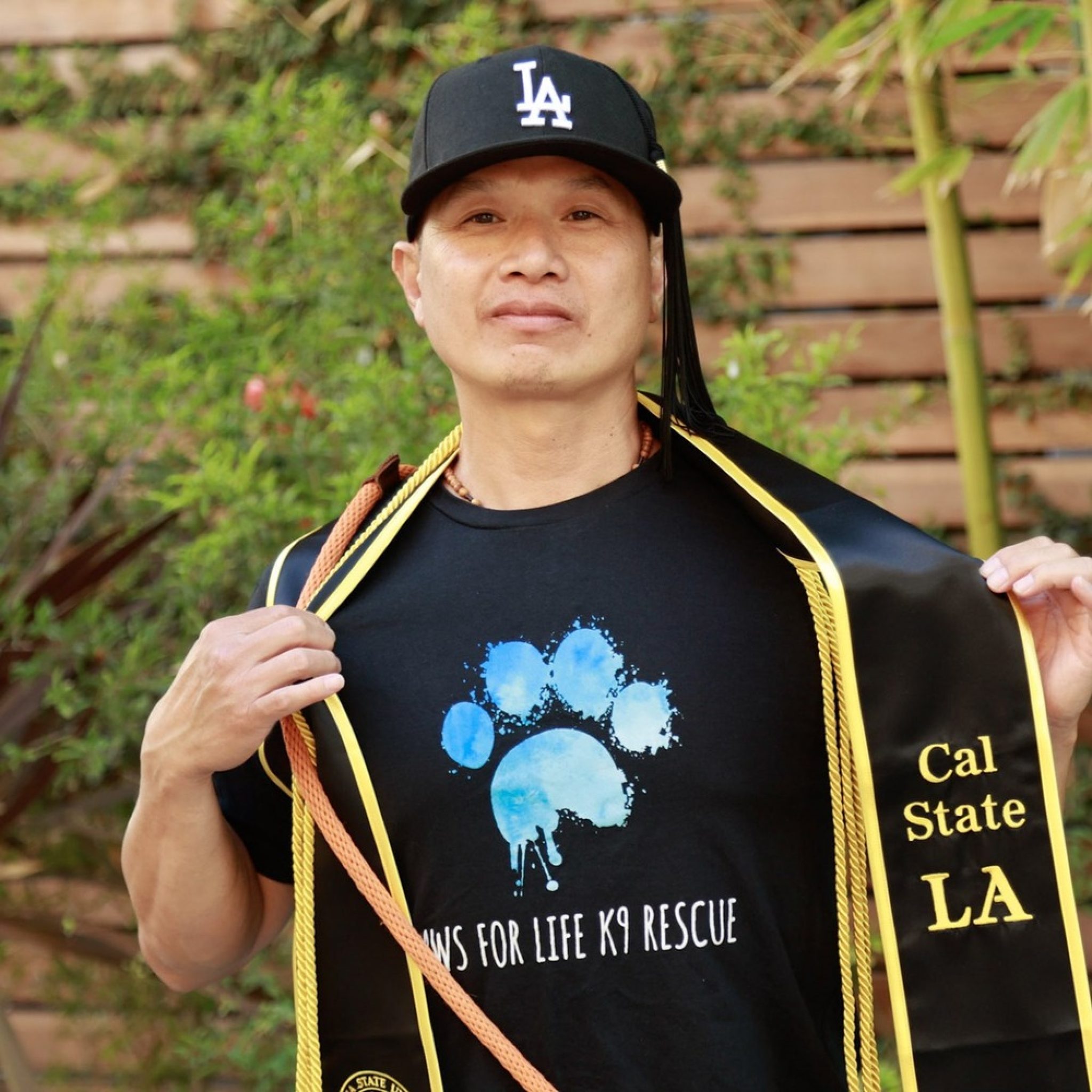 An image of a person formerly sentenced to LWOP wearing an academic stole.